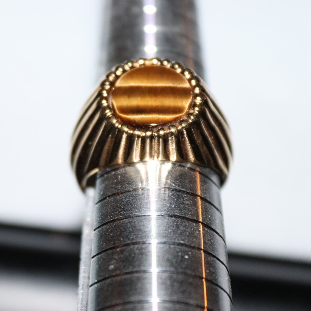 Park Lane gold toned with tigers eye like stone.  Size @ 11